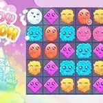 Skyer med ansikter, et slott, og ordet CLOUDY KINGDOM i fargerike bokstaver over en rutetabell med ansiktsformede ikoner