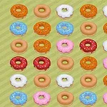 En rekke med fargerike donuts med ulike glasurer og strøssel er arrangert i et rutenett på en lysegrønn bakgrunn